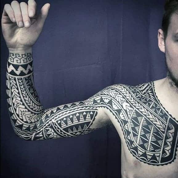 Arm and chest tribal tattoo with geometric patterns