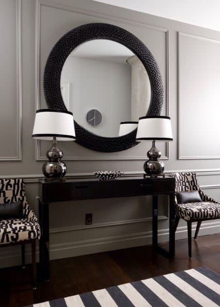 full wall wainscoting with circular mirror