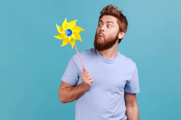 funny man blowing windmill