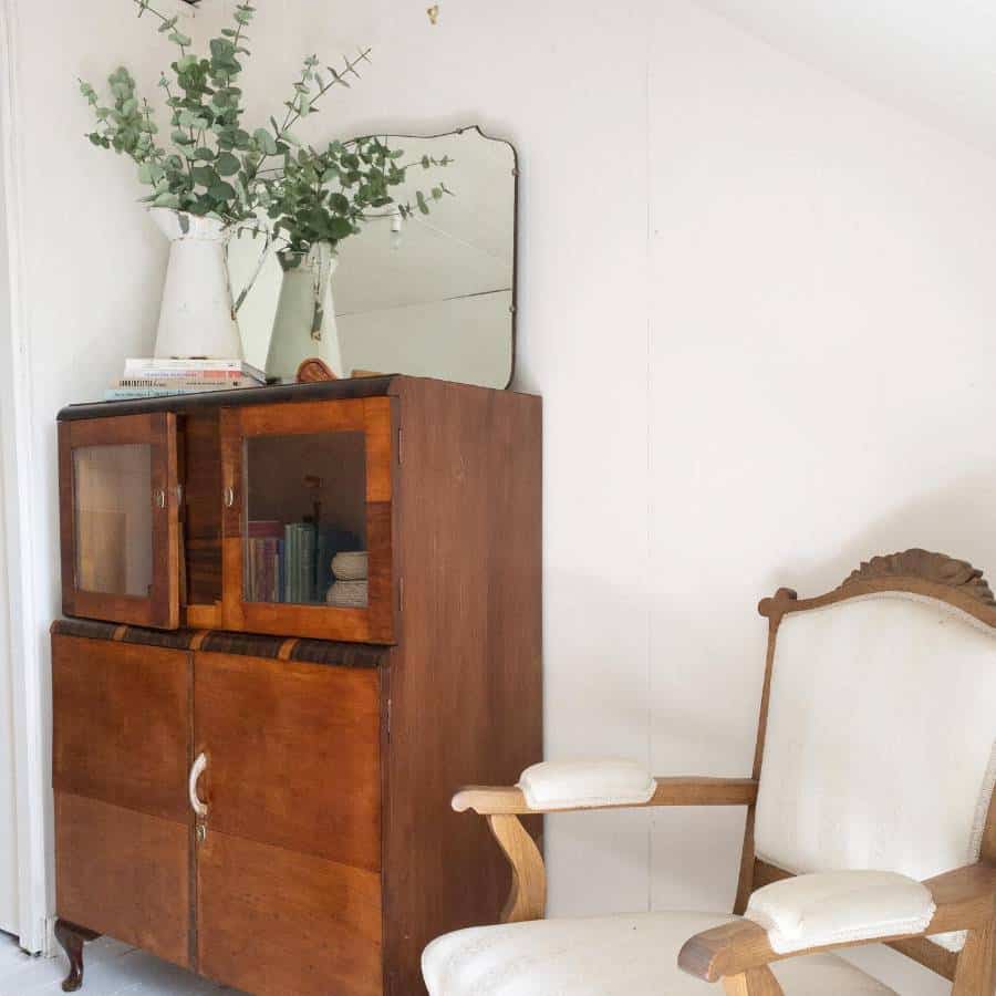 rustic wood cabinet with white accent chair 