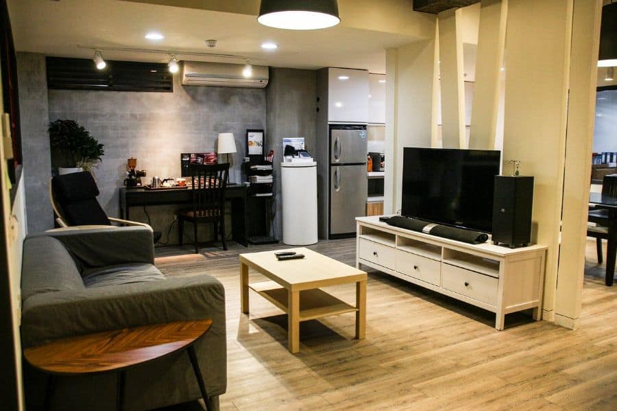 large open plan layout in apartment with exposed concrete wall