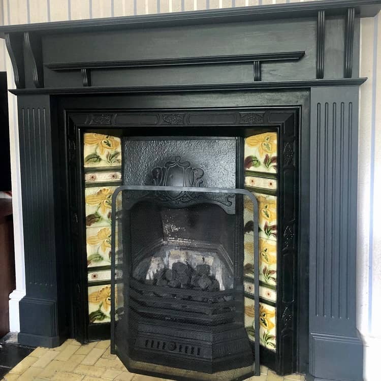 black fireplace surround floral tile