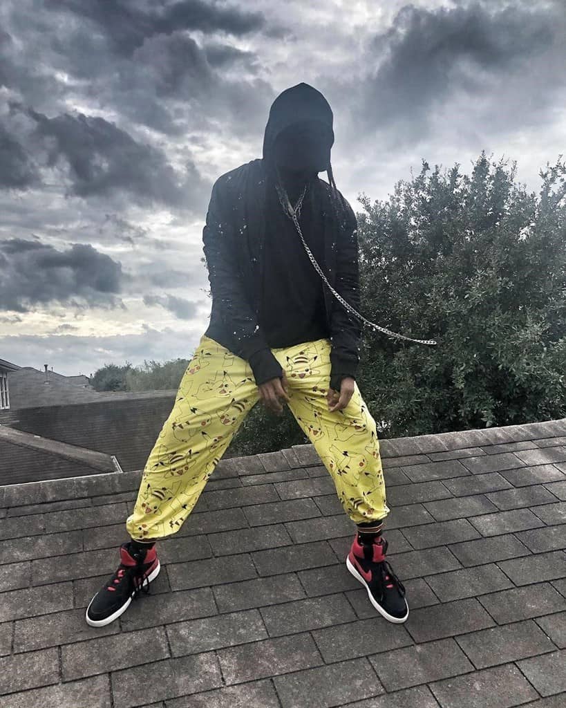 futuristic fashion for men black jacket and yellow pants