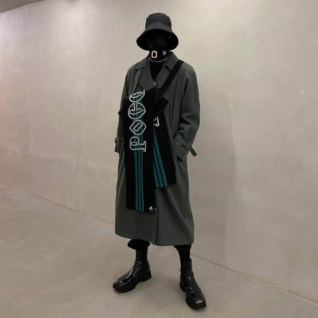 futuristic fashion for men dark colored trench coat with scarf