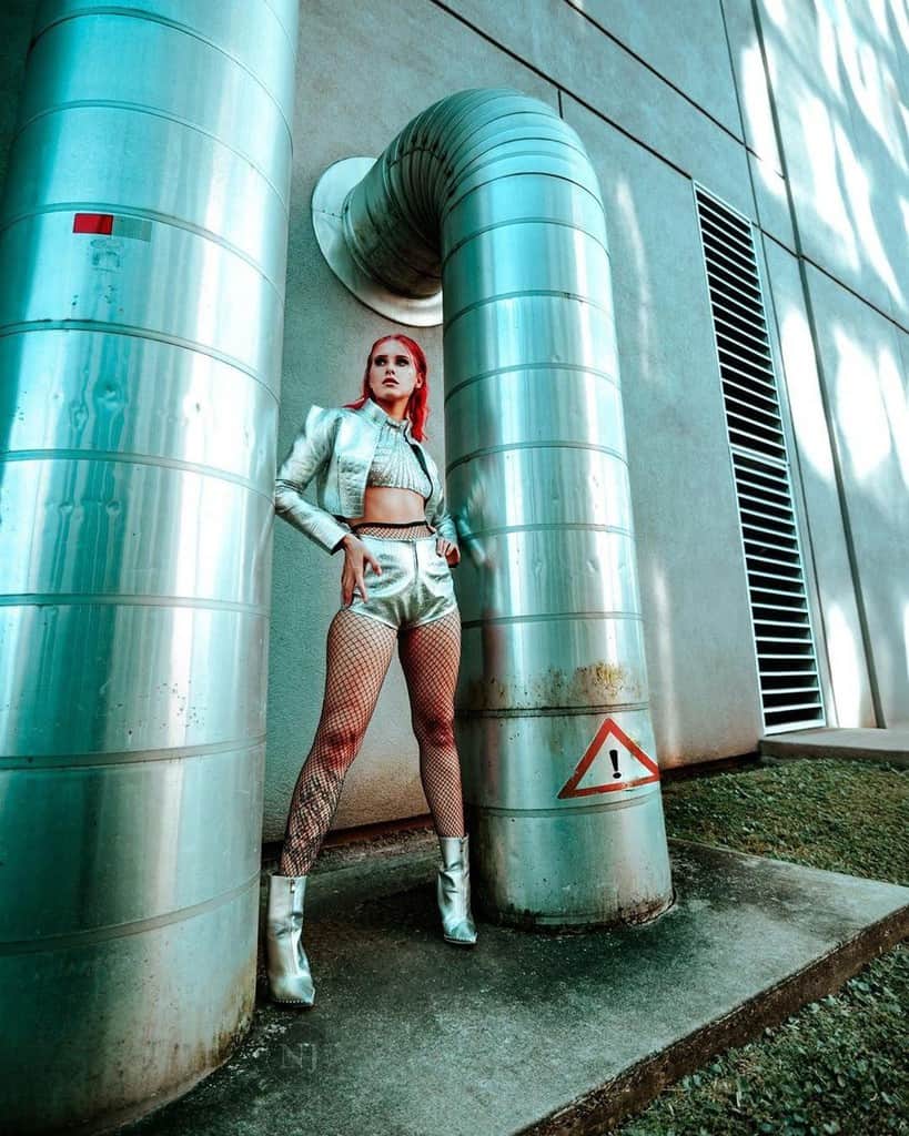 futuristic fashion silver metallic pair of jacket and short with fishnet stockings