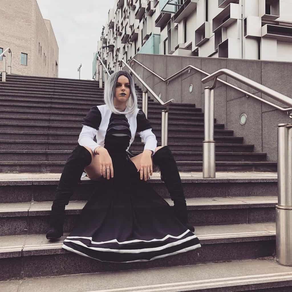 futuristic fashion with black and white outfit paired with black high boots