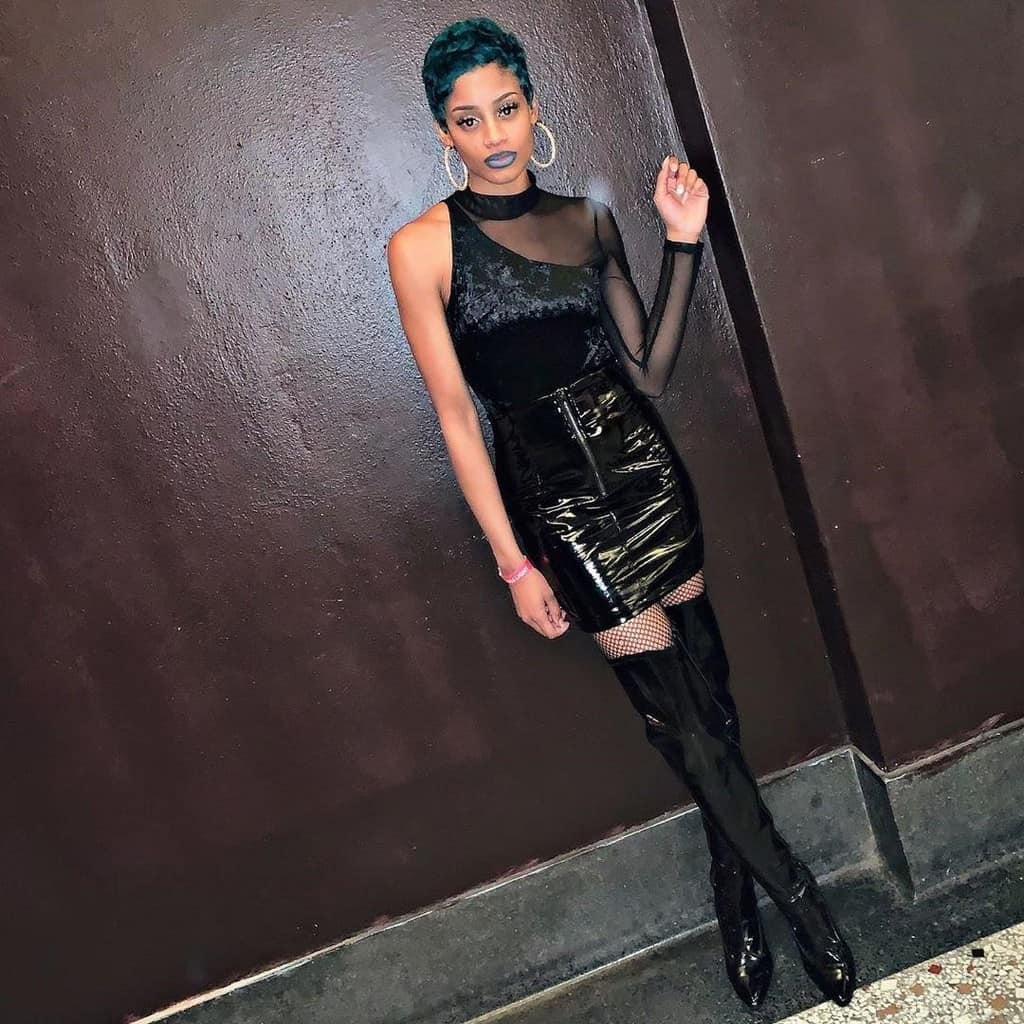 futuristic fashion with black dress and skirt and mesh sleeves