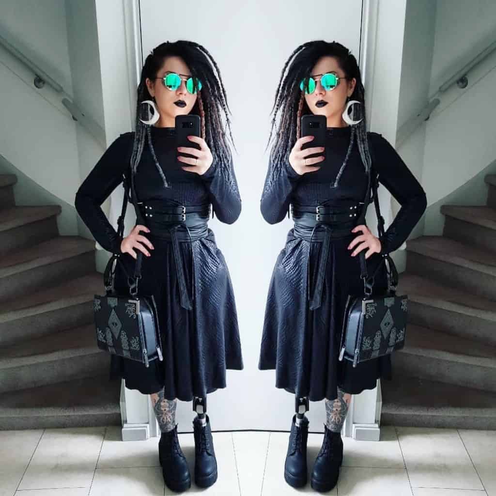 futuristic fashion with black long sleeves shirt and skirt and boots
