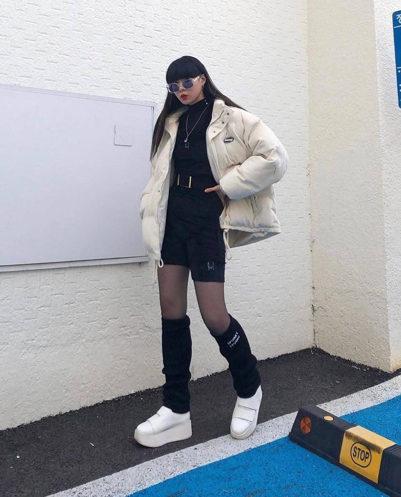 futuristic fashion with white puffer jacket and knee high socks
