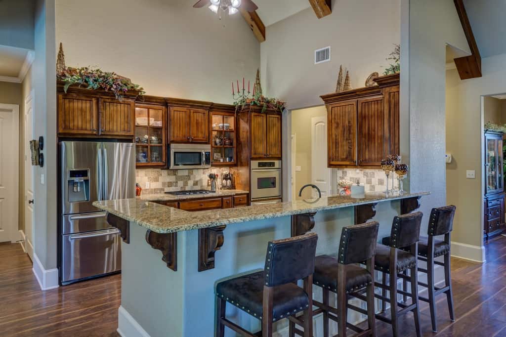 farmhouse kitchen wood cabinets breakfast bar wood floors