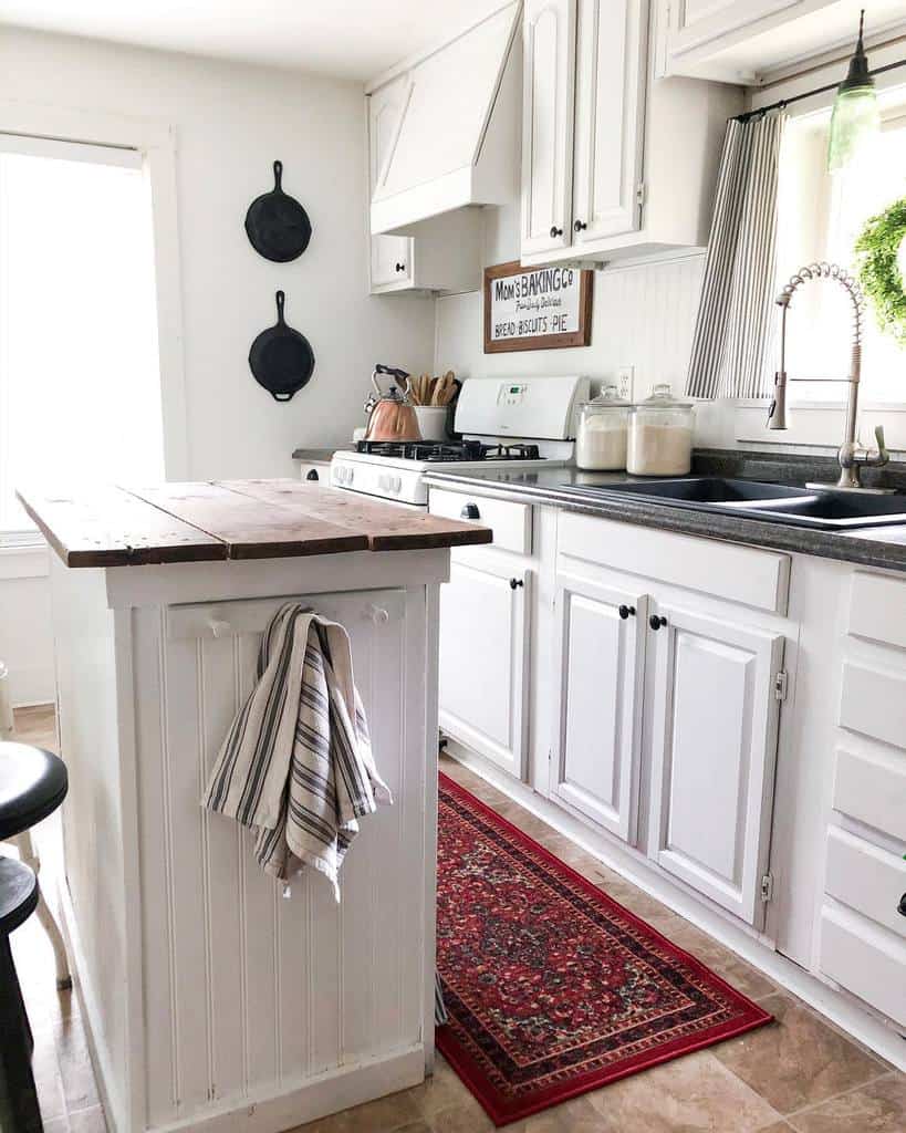 white modern farmhouse kitchen island with wood pallet countertop hanging pans 