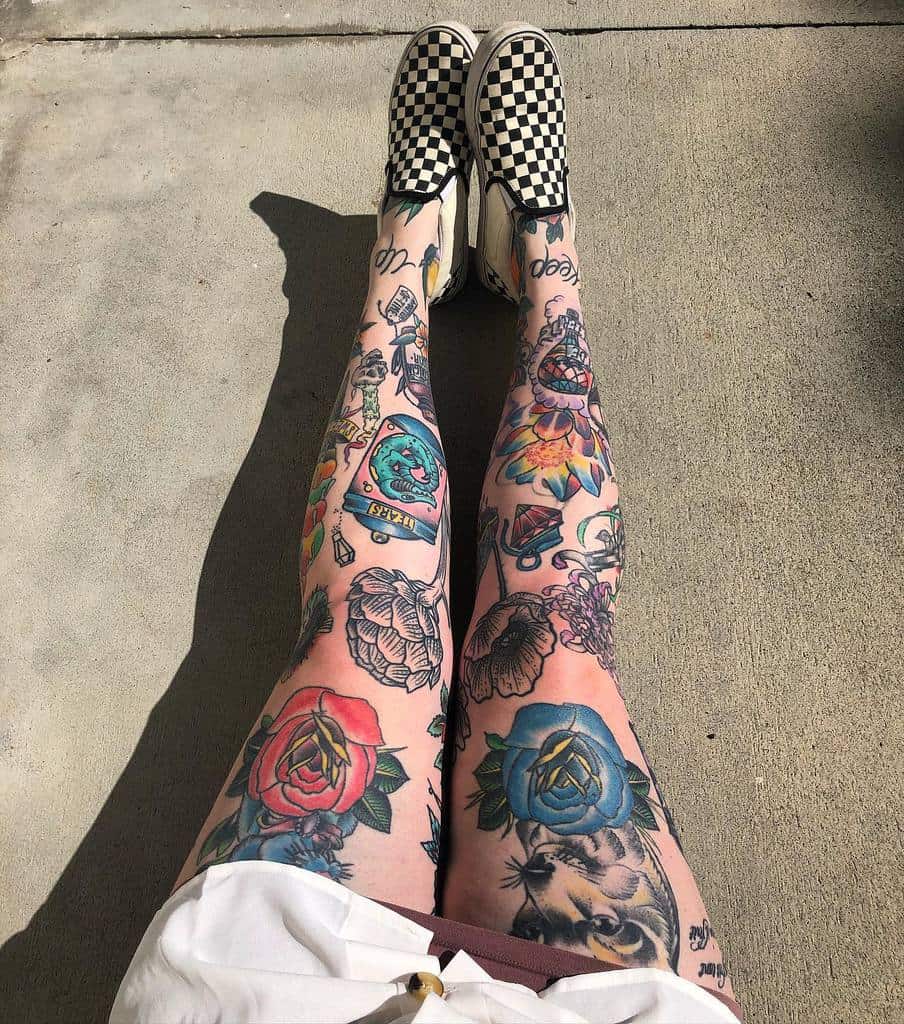 Vibrant tattoo leg sleeve, featuring bold designs including roses, a playful cat, vintage elements, and colorful floral patterns