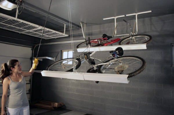 Efficient ceiling-mounted garage bike storage for saving floor space.