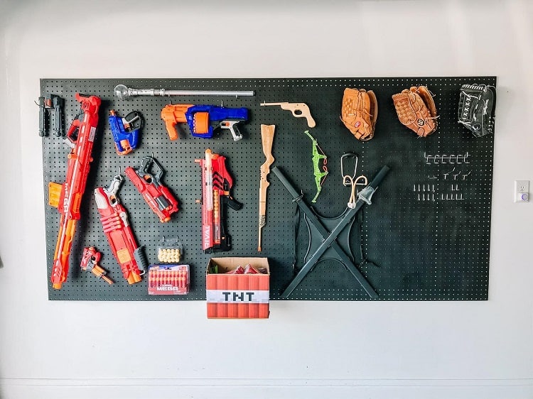 garage organization pegboard with nerf guns and sport equipment