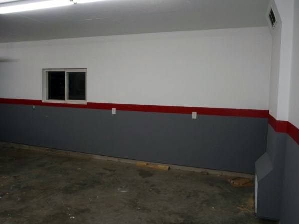 gray and white wall with red stripe in center