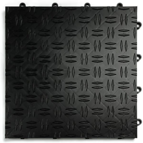 Black interlocking garage floor tile with a diamond tread pattern for slip resistance and durability.