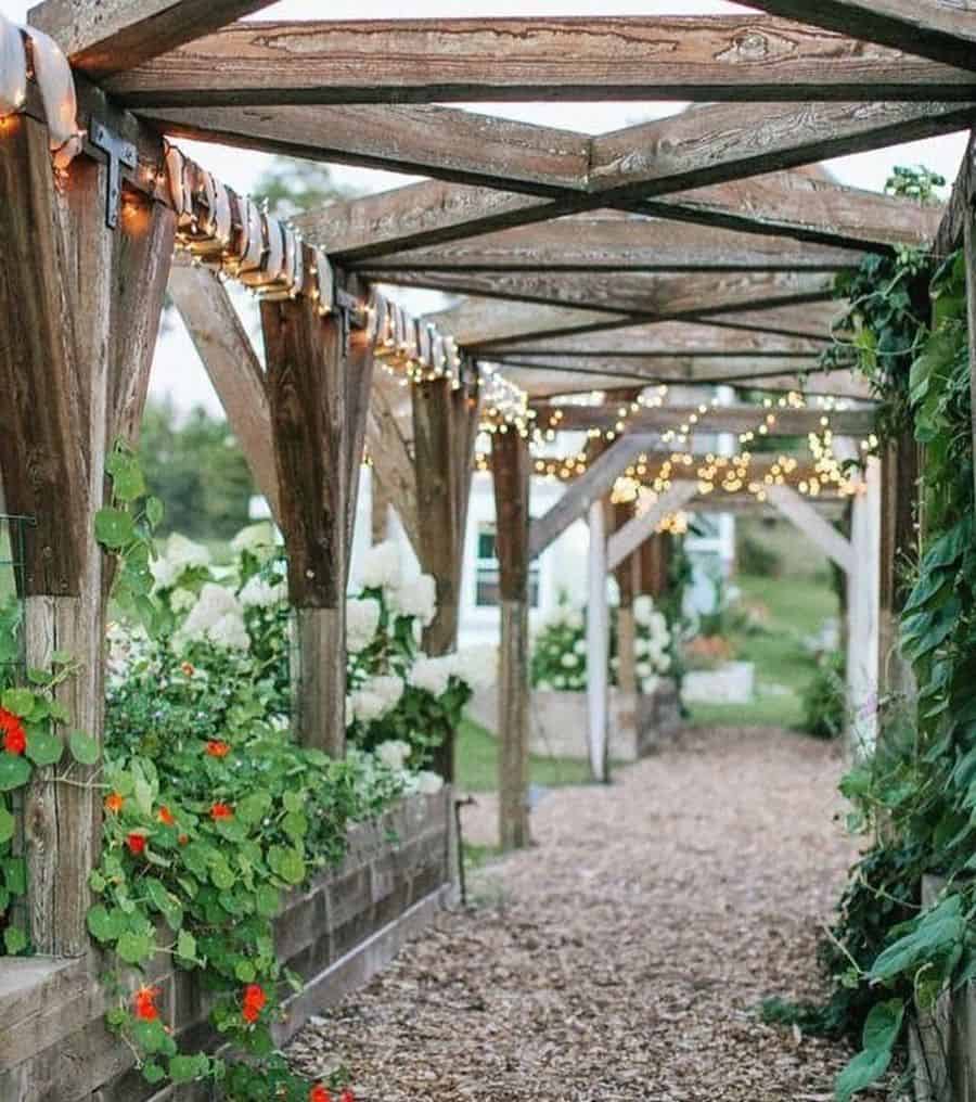 wood arch backyard fairy lights mulch path