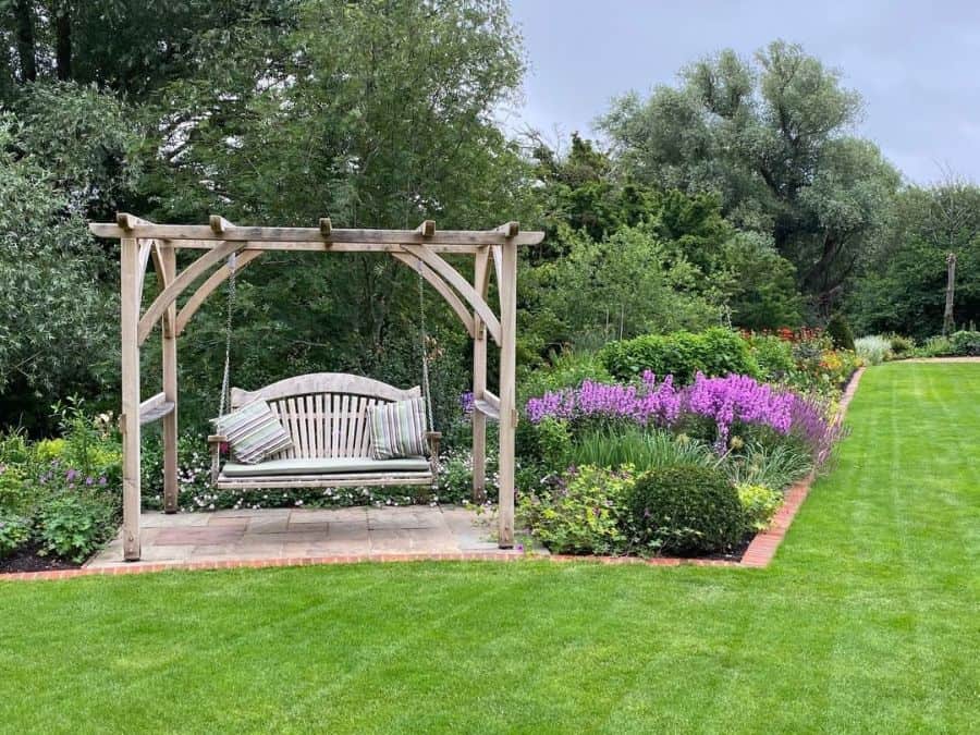 small wood gazebo hanging swing seat large grass area