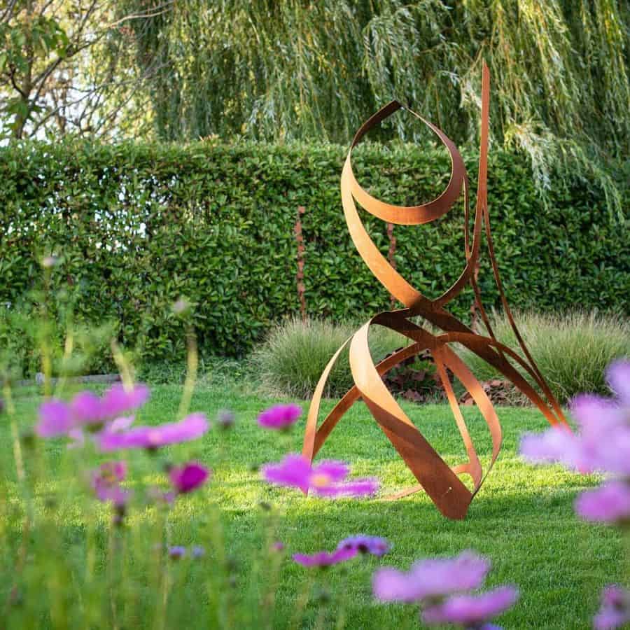 abstract copper art backyard garden purple flowers