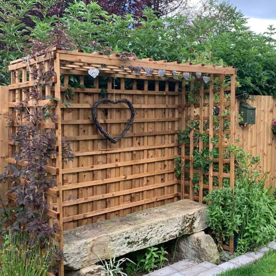stone bench wood lattice gazebo backyard