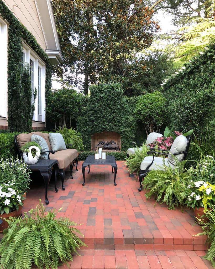 brick garden patio with ornate furniture and fireplace