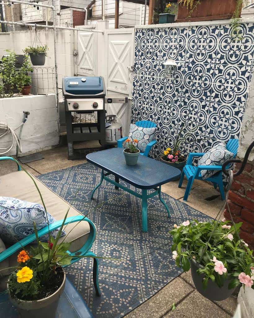 pattern tile accent wall in small backyard patio with bbq