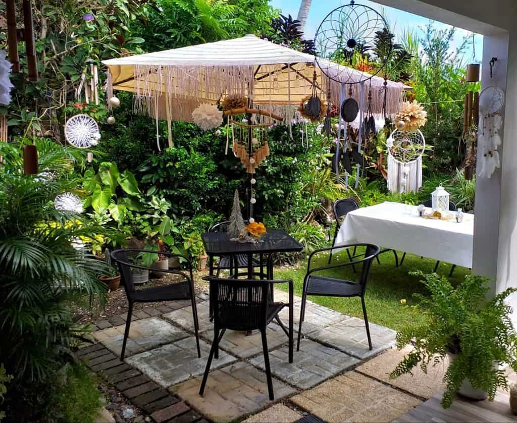 small boho garden with black table and chairs