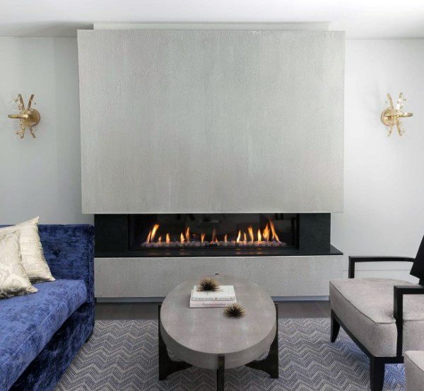 Contemporary gas fireplace with a sleek concrete surround in a stylish living room setting.