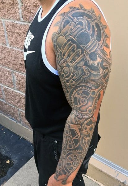 Individual displaying a detailed mechanical-themed tattoo sleeve on their right arm
