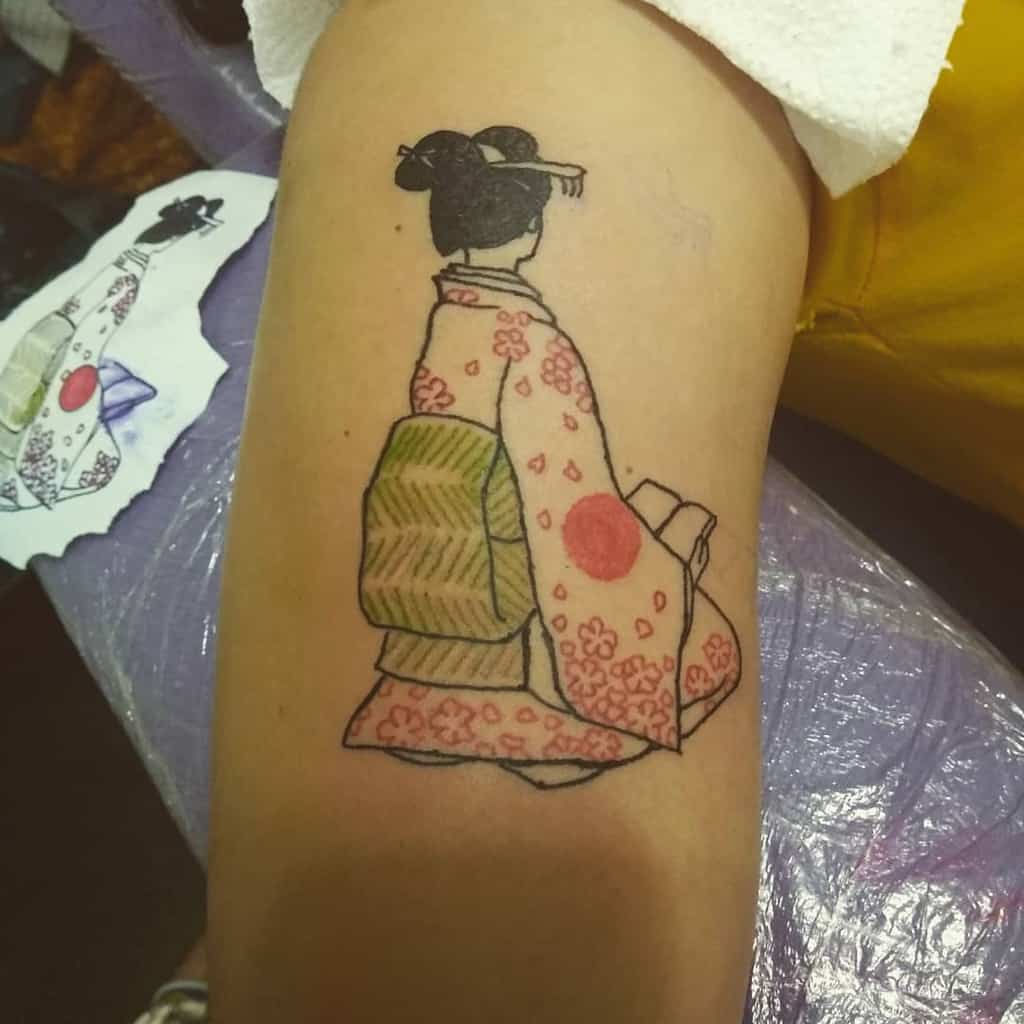 Minimalist tattoo of a Geisha in a pink floral kimono with a green obi, seated with her back turned, inspired by traditional Japanese art.