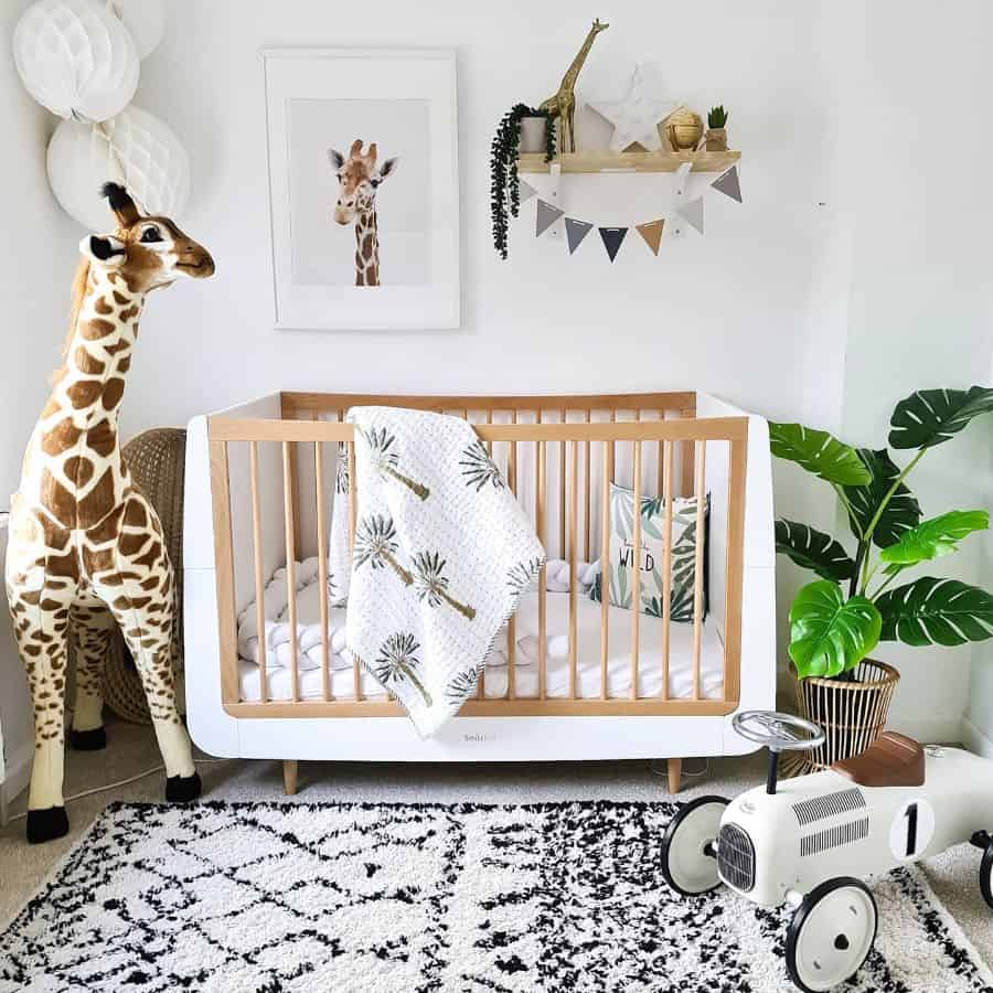 nursery white crib toy car stuffed giraffe pot plant