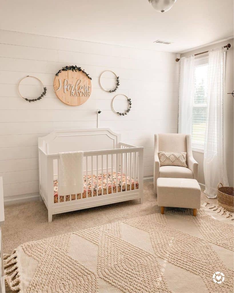 beige nursery white crib sofa chair and footrest white shiplap walls
