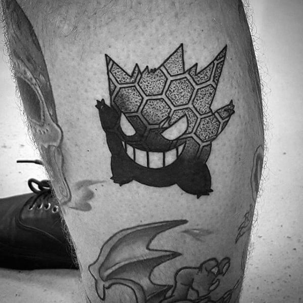 Unique blackwork Gengar tattoo with a honeycomb pattern on its head, combining geometric detail with a bold silhouette style.