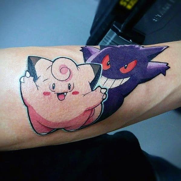 Playful tattoo of Clefairy and Gengar side by side, blending cute and mischievous vibes in a vibrant, cartoon-style design.