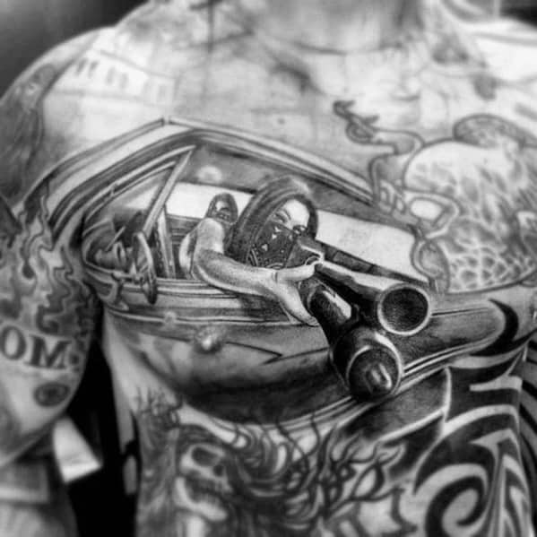 Realistic black and grey chest tattoo of a masked figure aiming a shotgun from a car window, creating a bold and intense 3D effect.