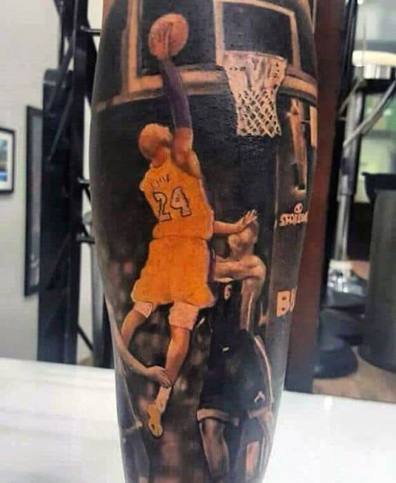 A dynamic tattoo of Kobe Bryant in action, performing a dunk while wearing his Lakers jersey, with his number 24 visible.