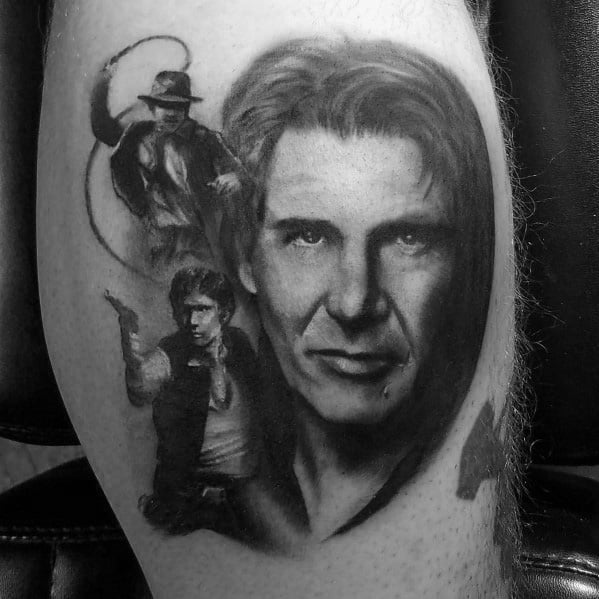 Black and gray tattoo featuring Harrison Ford, with iconic portraits of Indiana Jones wielding a whip and Han Solo aiming a blaster.