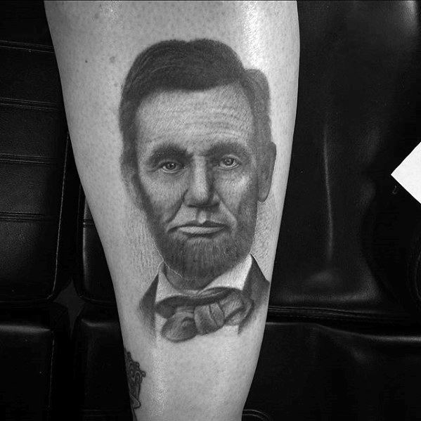 Tattoo of a bearded man's face resembling Abraham Lincoln on a person's leg