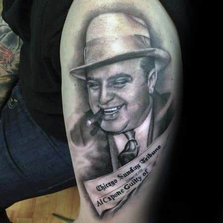 Al Capone tattoo featuring a smiling portrait of the gangster with a cigar, accompanied by a newspaper clipping reading "Chicago Sunday Tribune, Al Capone Guilty of..."