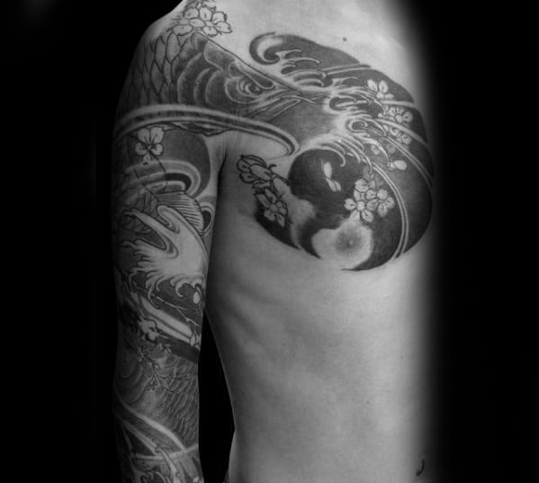 Gentleman With Arowana Fish Chest And Sleeve Tattoo