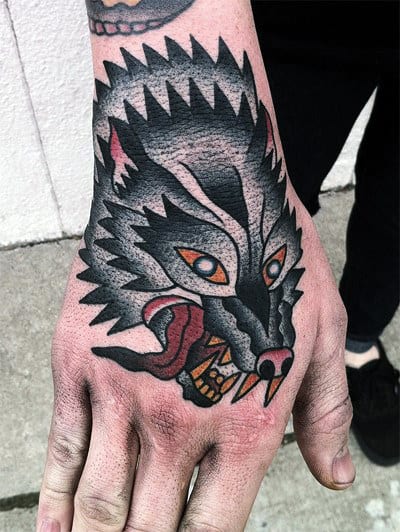 Gentleman With Awesome Traditional Wolf Hand Tattoo