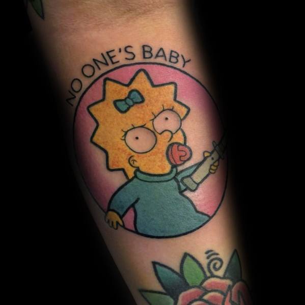 Bold tattoo of Maggie Simpson holding a gun with 'No One’s Baby' text above, featuring a pink circular background.