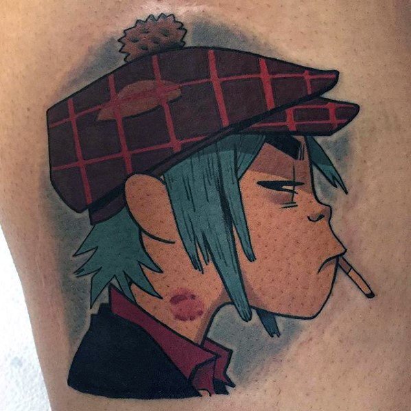 Color tattoo of Murdoc from Gorillaz in profile, wearing a red plaid hat, smoking a cigarette, with a lipstick kiss mark on his neck.