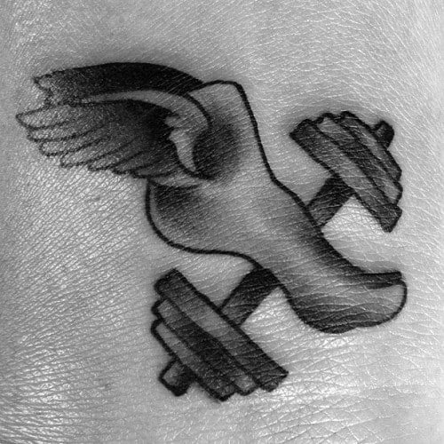 Black and grey tattoo of a winged foot stepping on a dumbbell, symbolizing speed, strength, and athletic endurance.