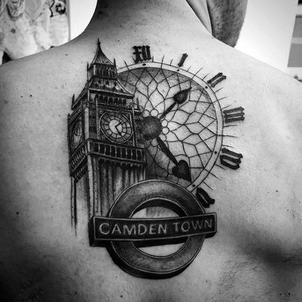 Detailed black and grey tattoo on the back featuring Big Ben, a London Underground "Camden Town" sign, and a clock face with intricate shading and design.