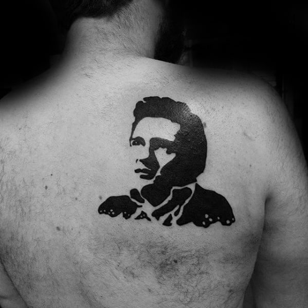 Back tattoo of Johnny Cash's portrait, done in bold black ink on the back