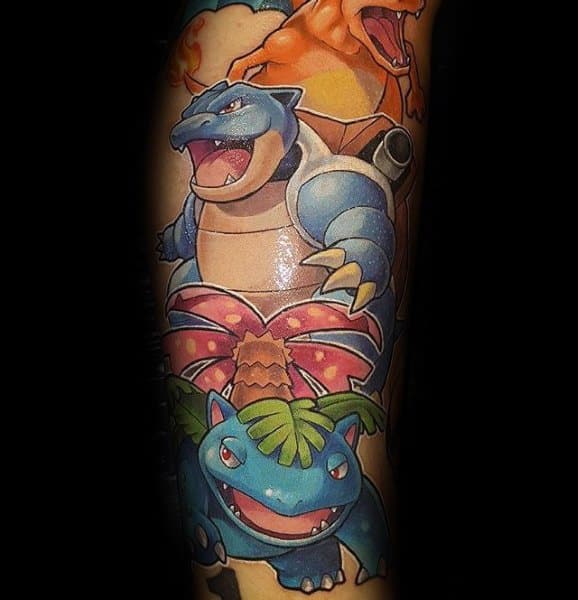 Vibrant tattoo featuring Charizard, Blastoise, and Venusaur together, showcasing the original Kanto starter evolutions in full color.