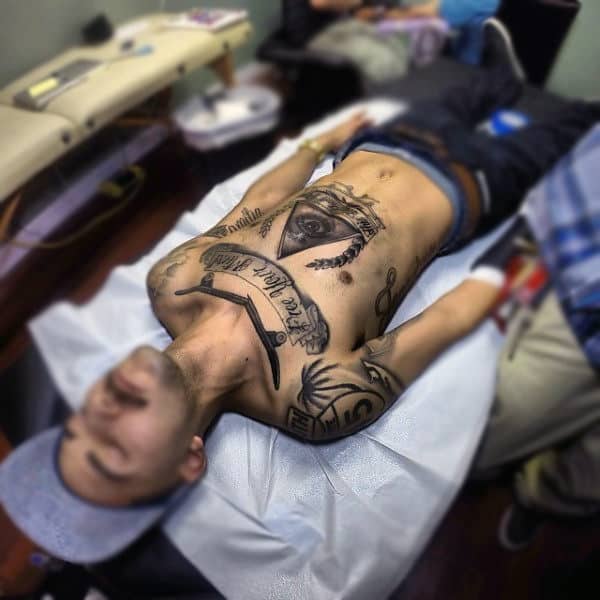 Gentleman With Broken Snapped Skateboard Deck Tattoo On Upper Chest