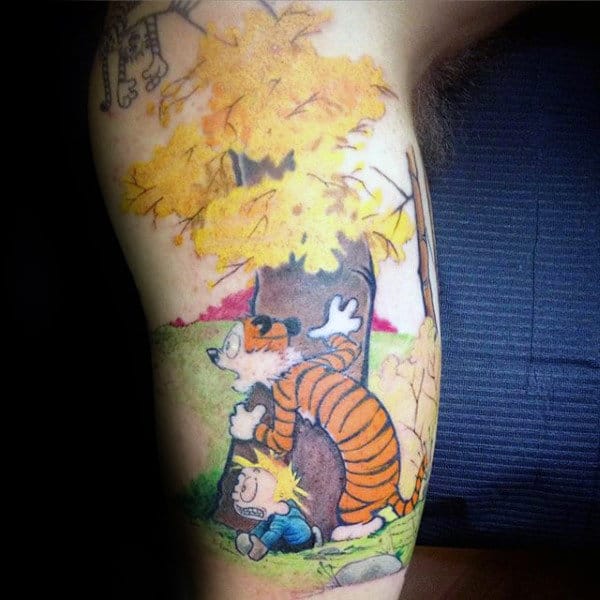 Gentleman With Calvin And Hobbes Behind Tree Tattoo On Arm