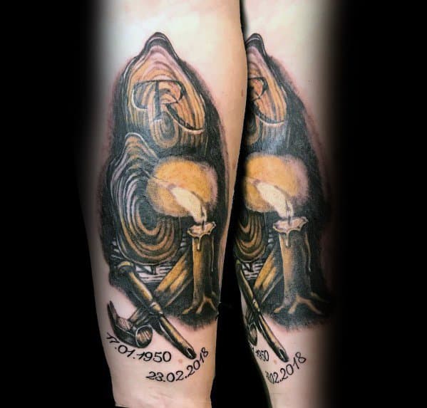 Tattoo of a wood carving scene with a chisel, mallet, and memorial dates, symbolizing craftsmanship, dedication, and remembrance.